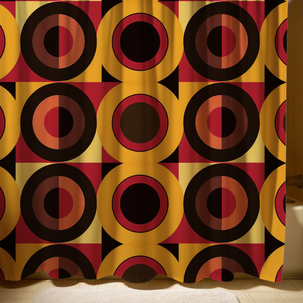 Colorful retro-modern shower curtain featuring geometric circles and squares in bold hues of orange, red, yellow, and black, set in a well-lit bathroom.